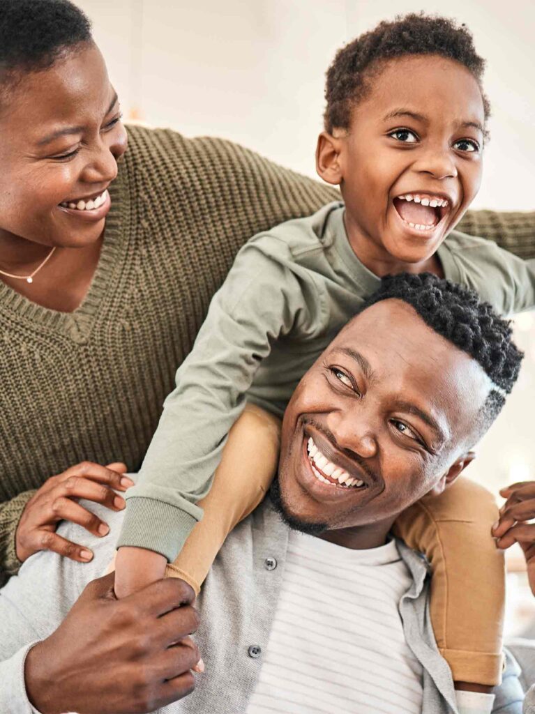 Outside of a blue, cottage-style home purchased using a down payment assistance program.