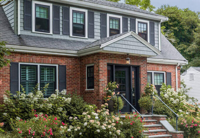 Exterior brick house with flowers and bushes