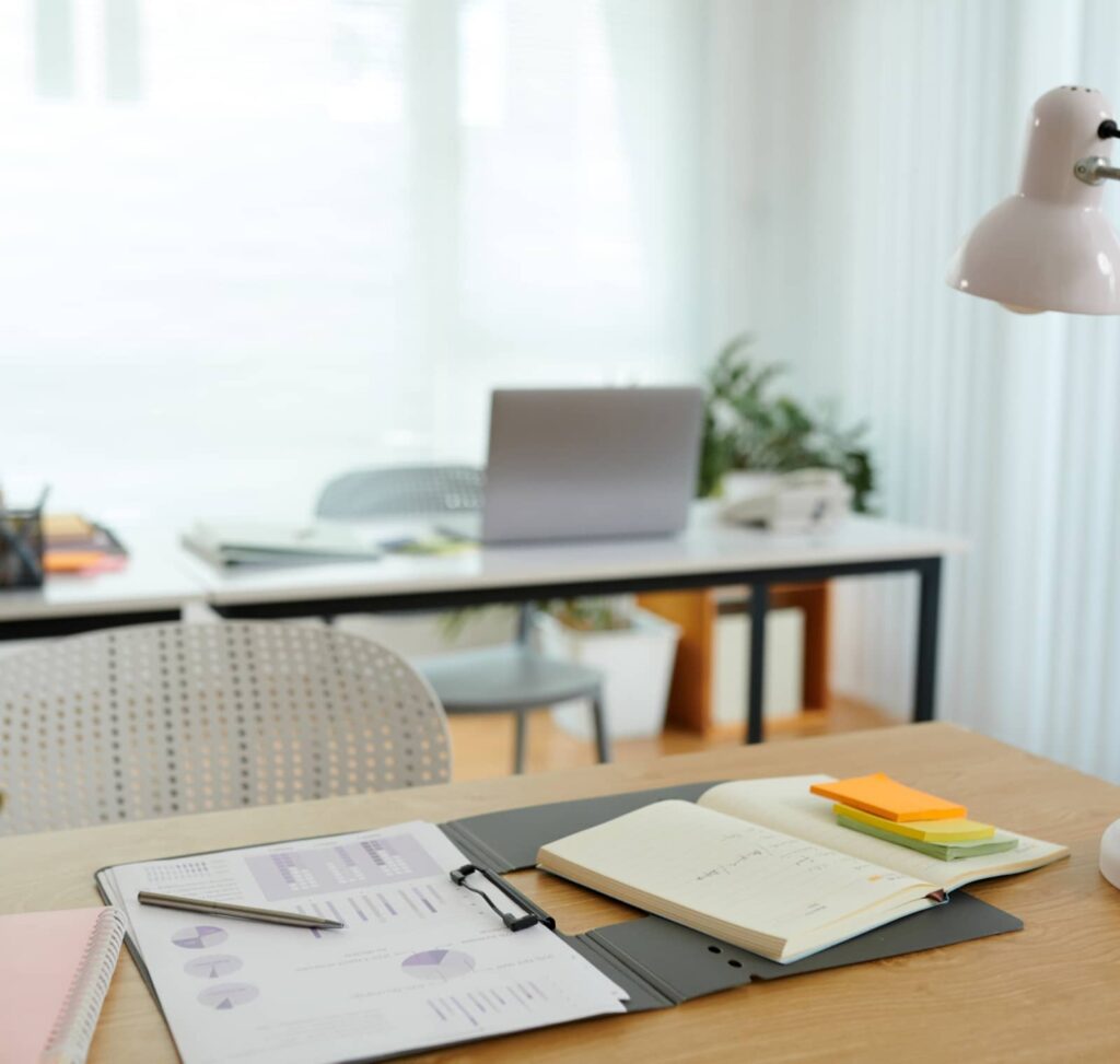 Paperwork spread out on a desk to help calculate closing costs.