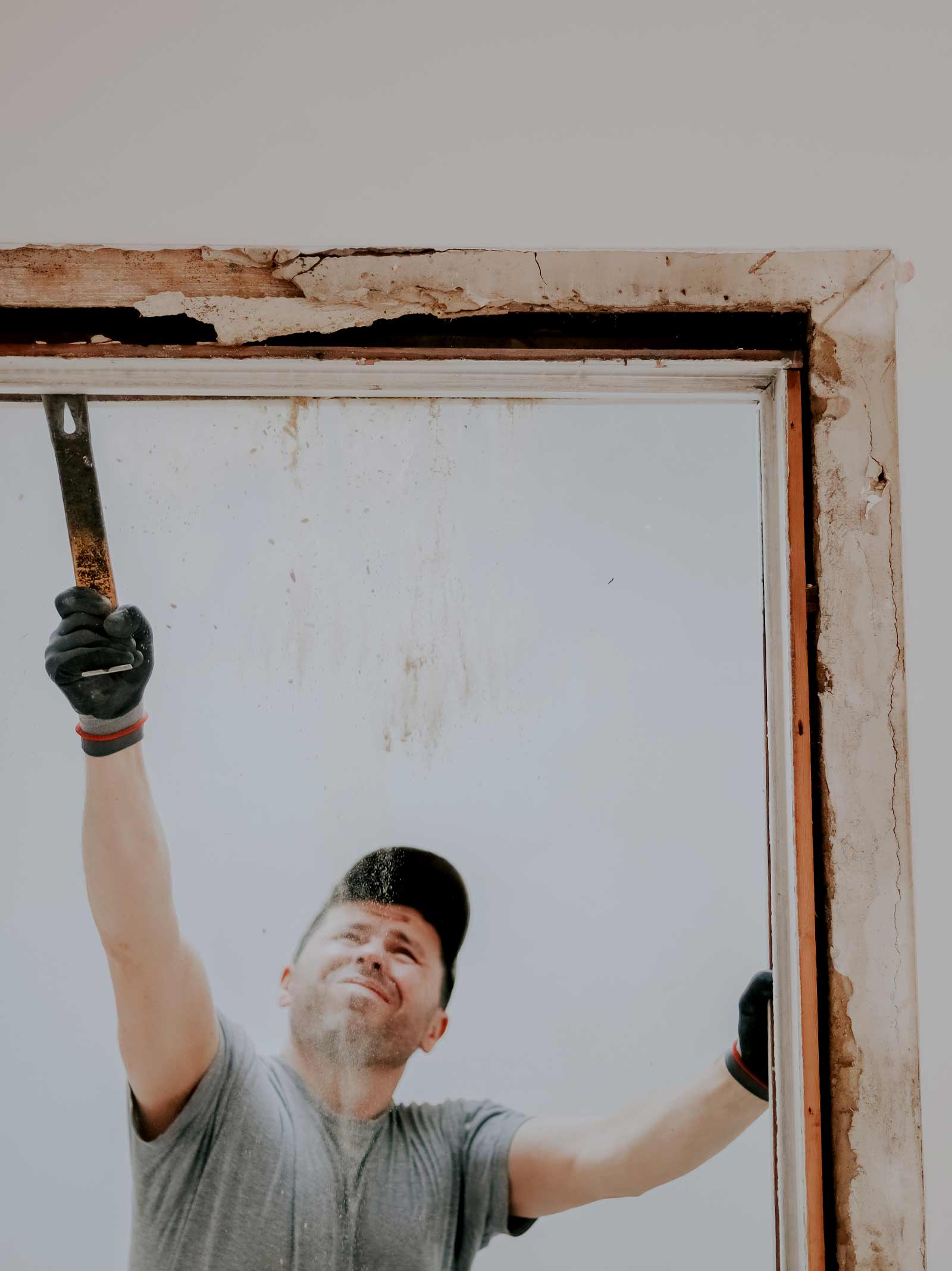 Man does a doorway demo during home improvement project financed using a renovation HELOC.
