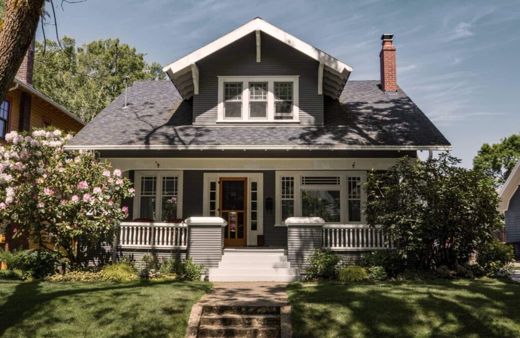 Exterior of a blue home going through the homebuying process.