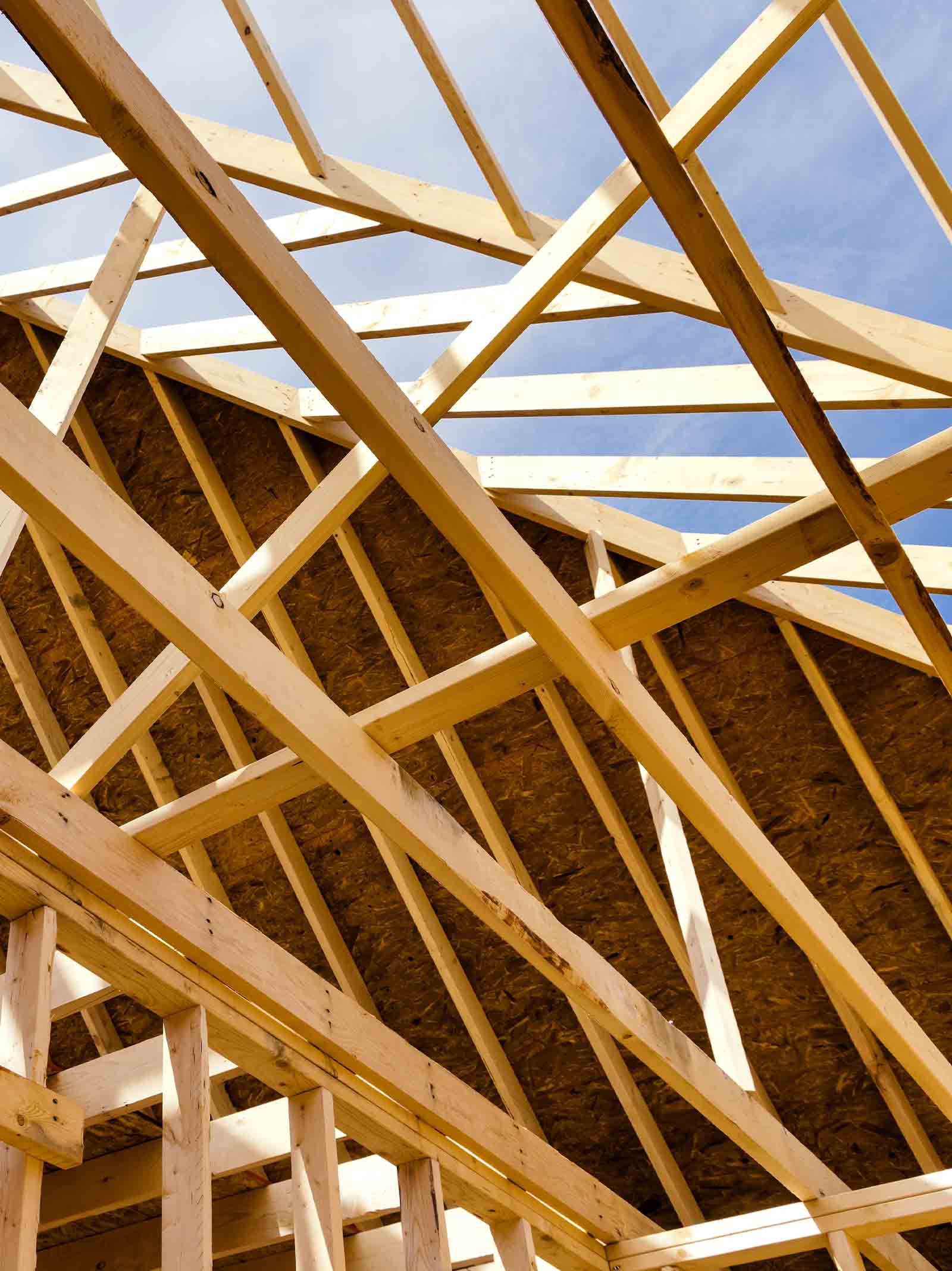 Wooden beams in the framing stage of a home being built using a one-time close construction home.