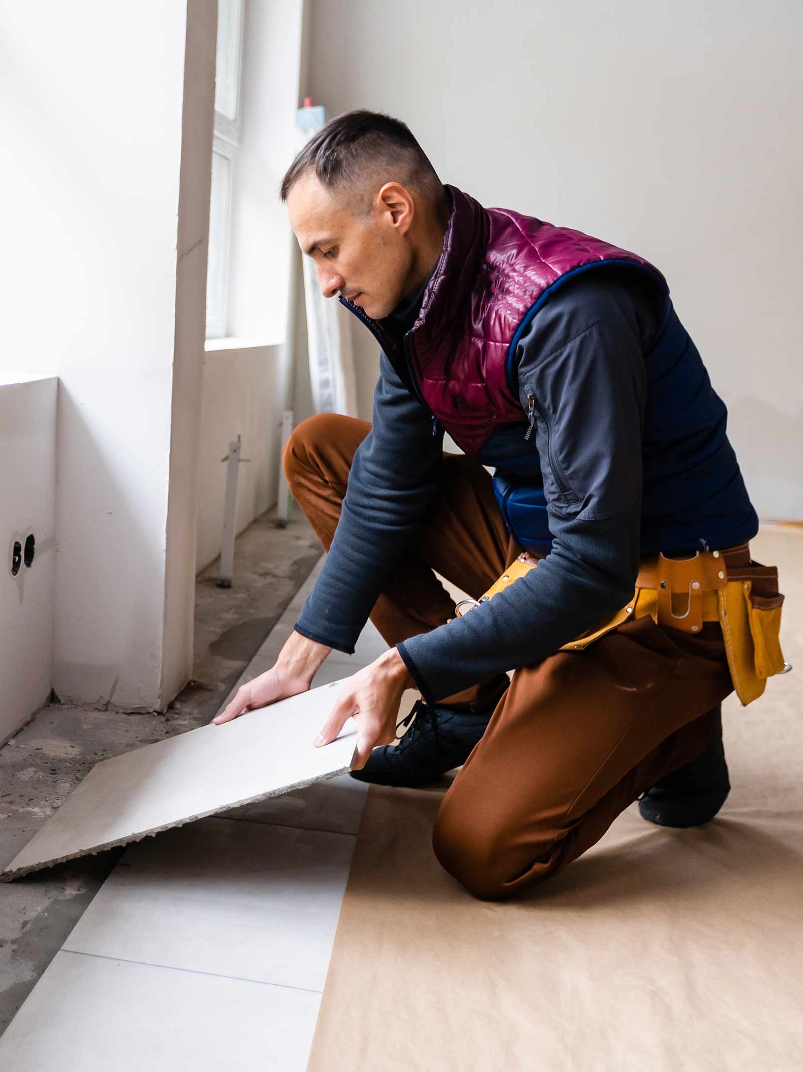 Contractor installs tile inside of a home being renovated using an FHA 203k loan.