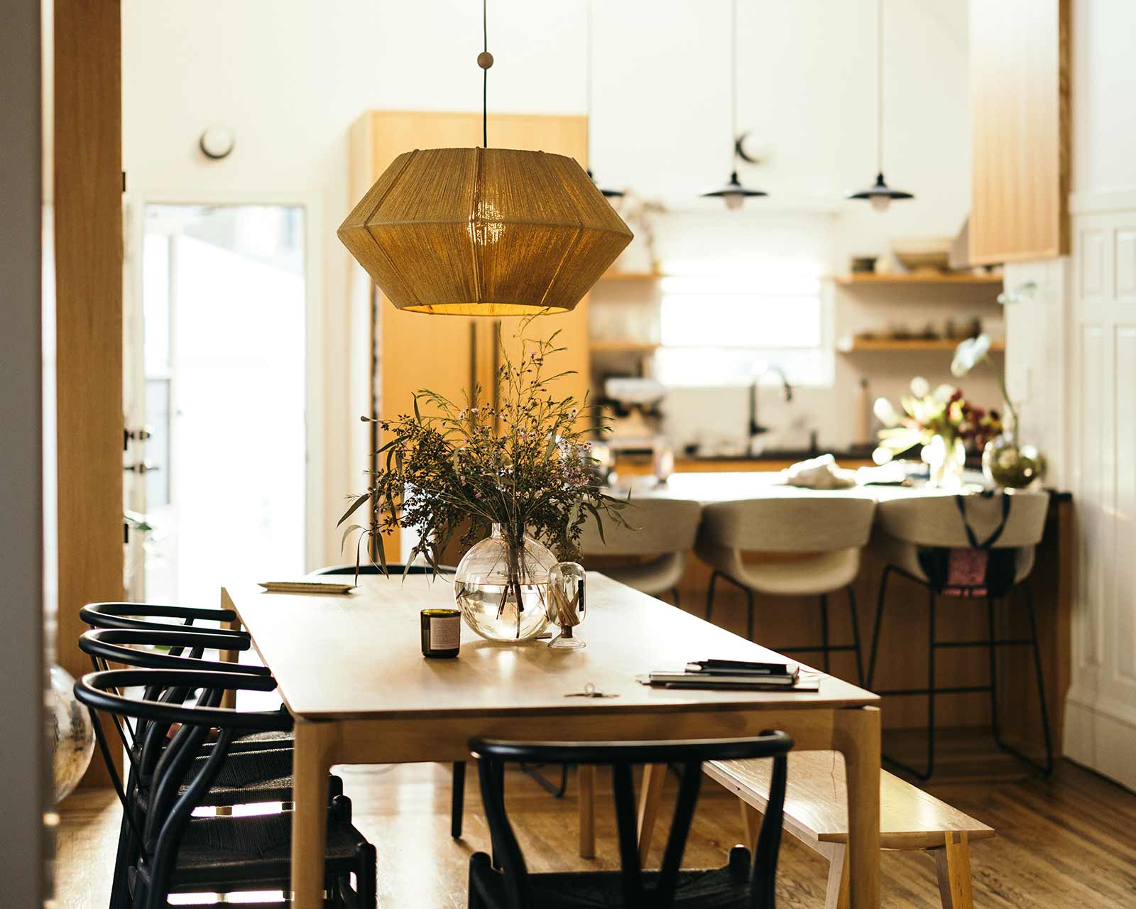 Light, open-air interior of a kitchen and dining room at a loan officer’s home.