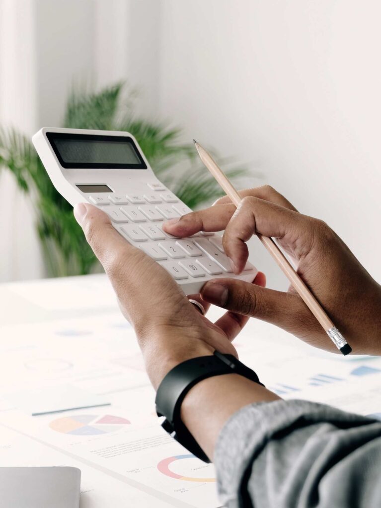 Man uses calculator to discover refinance mortgage rates.
