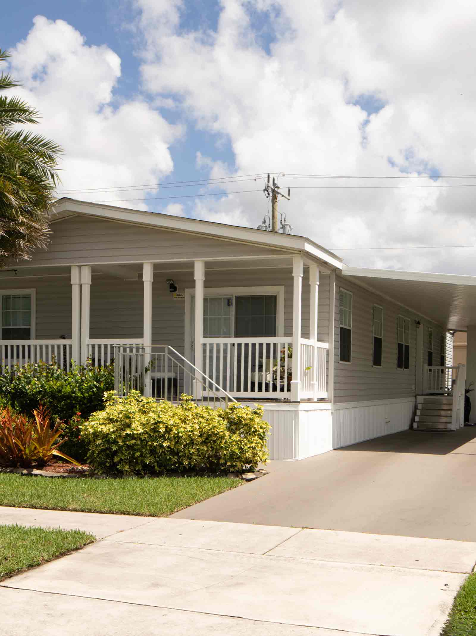 Outside of a mobile home with a carport purchased using a manufactured home loan.