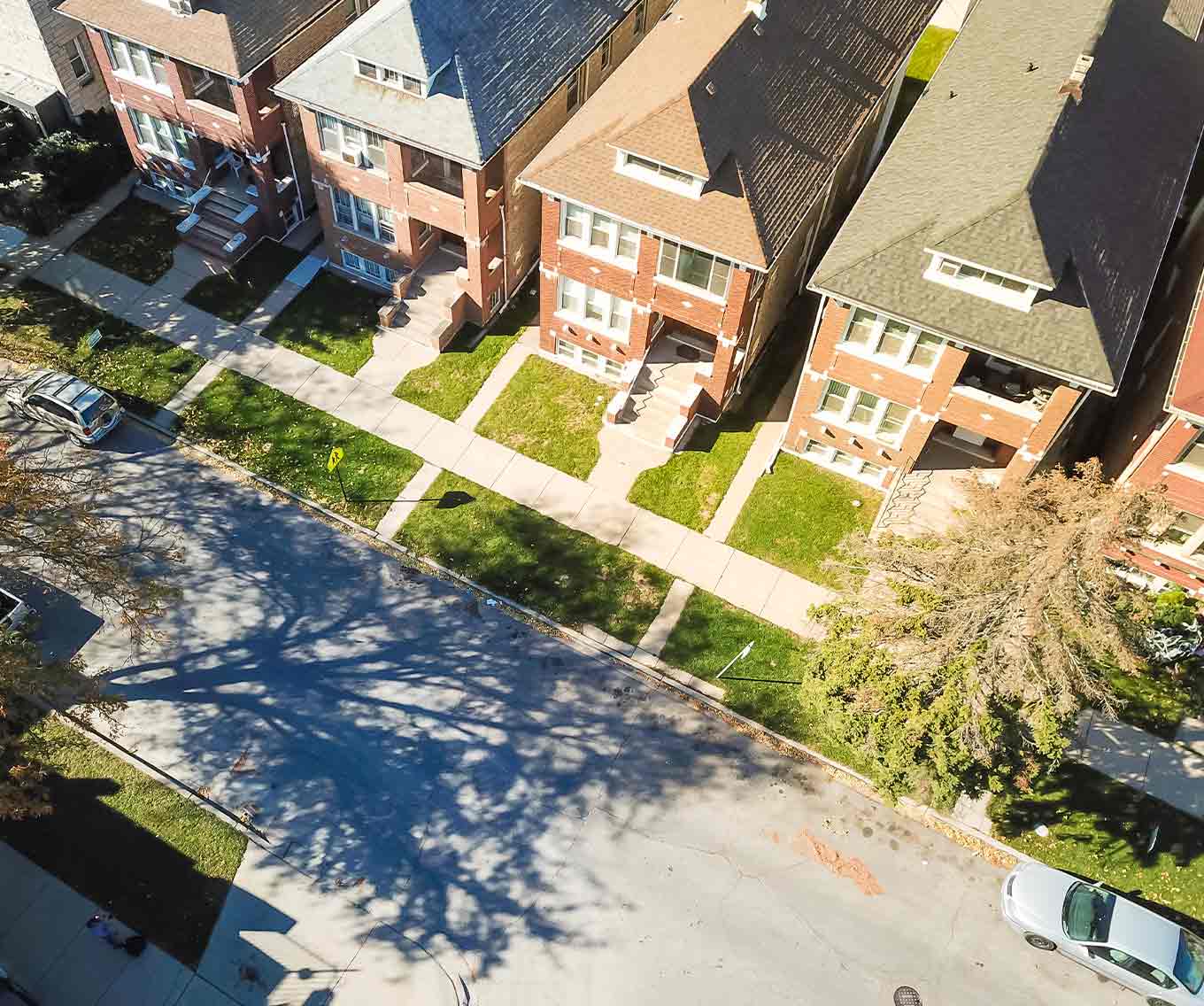 Exterior of street filled with owner-occupied, multi-family homes of 2-4 unit properties
