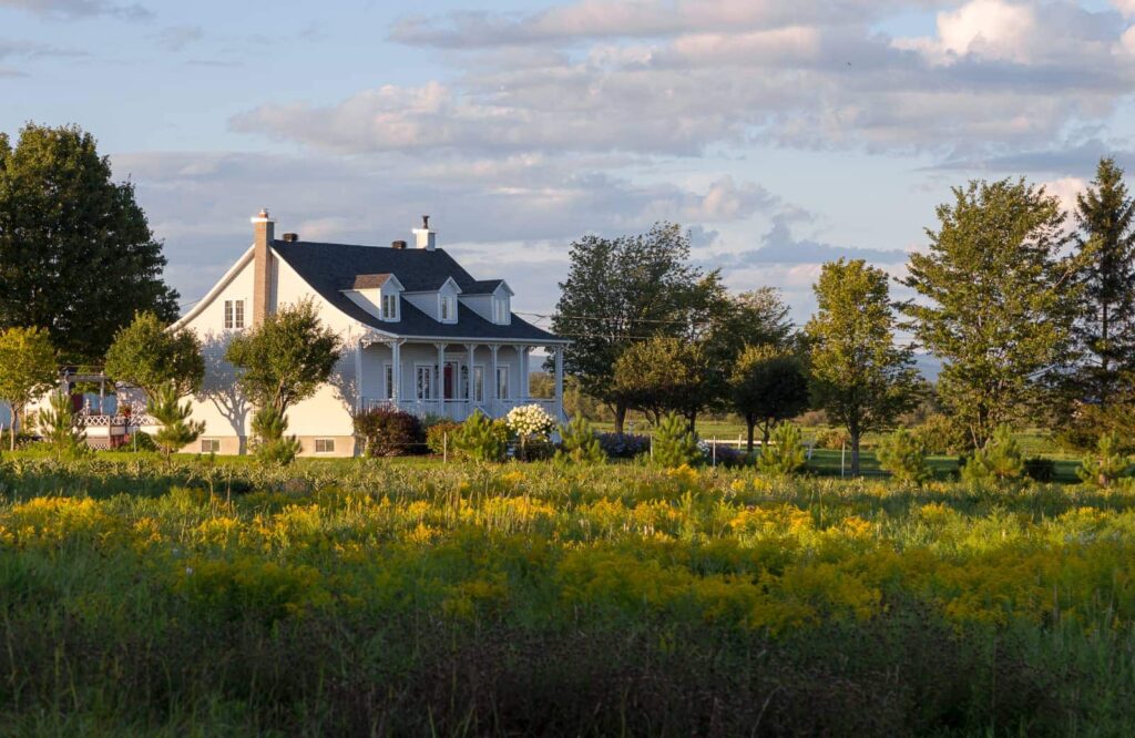 Outside of rural home purchased using a USDA loan surrounded by a field.